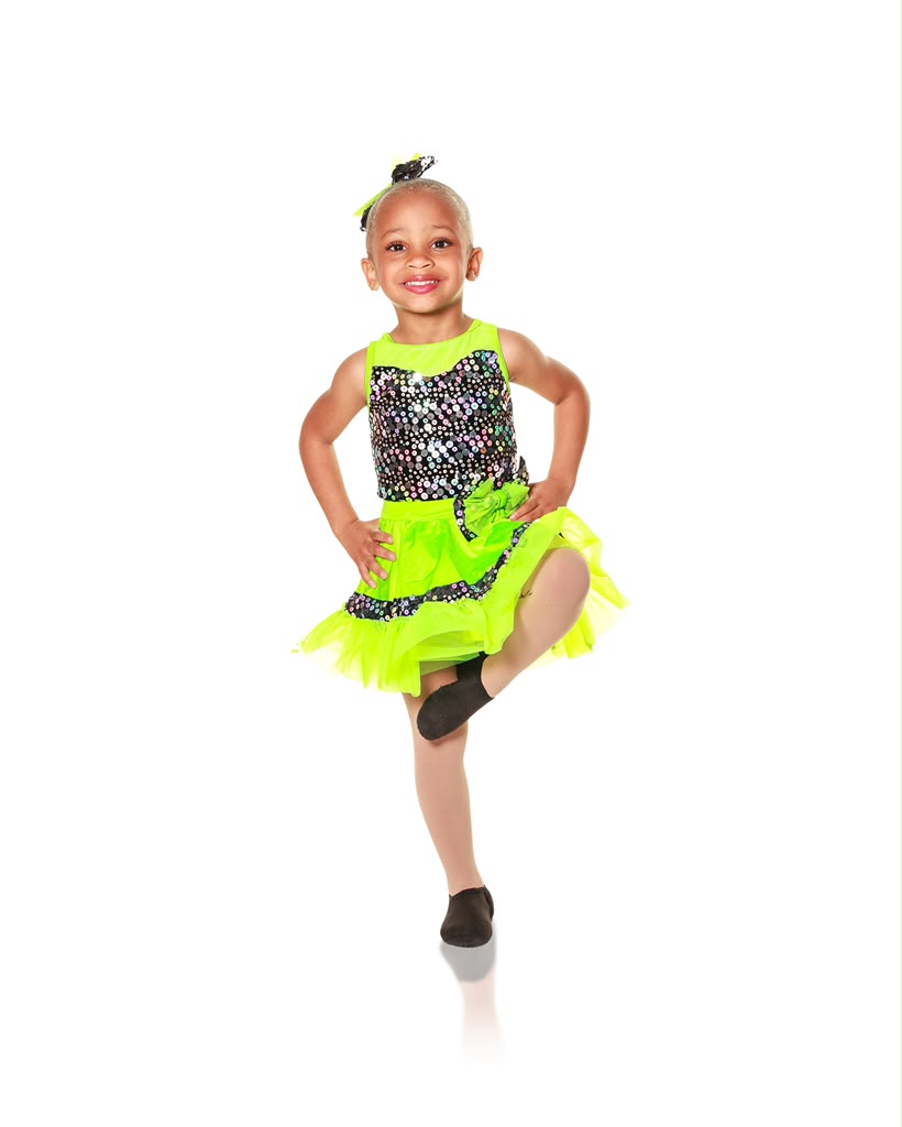Kreelyn balancing on one leg in a neon green jazz costume