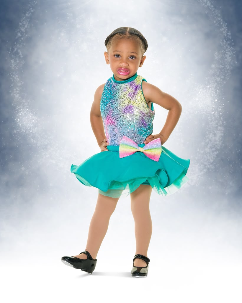 Kreelyn in a teal sequined costume with tap shoes